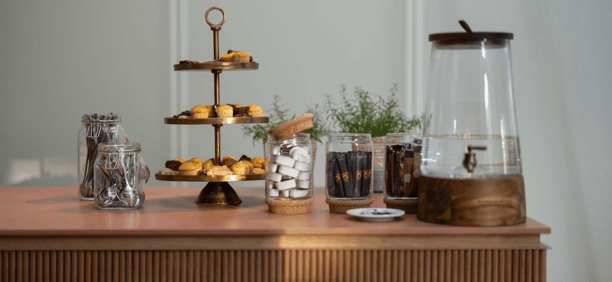 Coffee table with pastries and jars of essentials