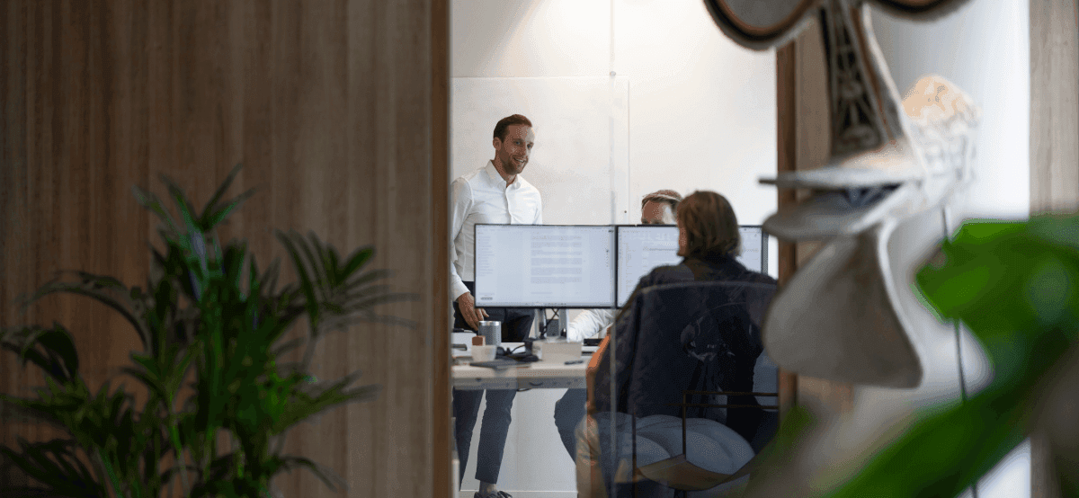 Colleagues meeting with laptops in office room