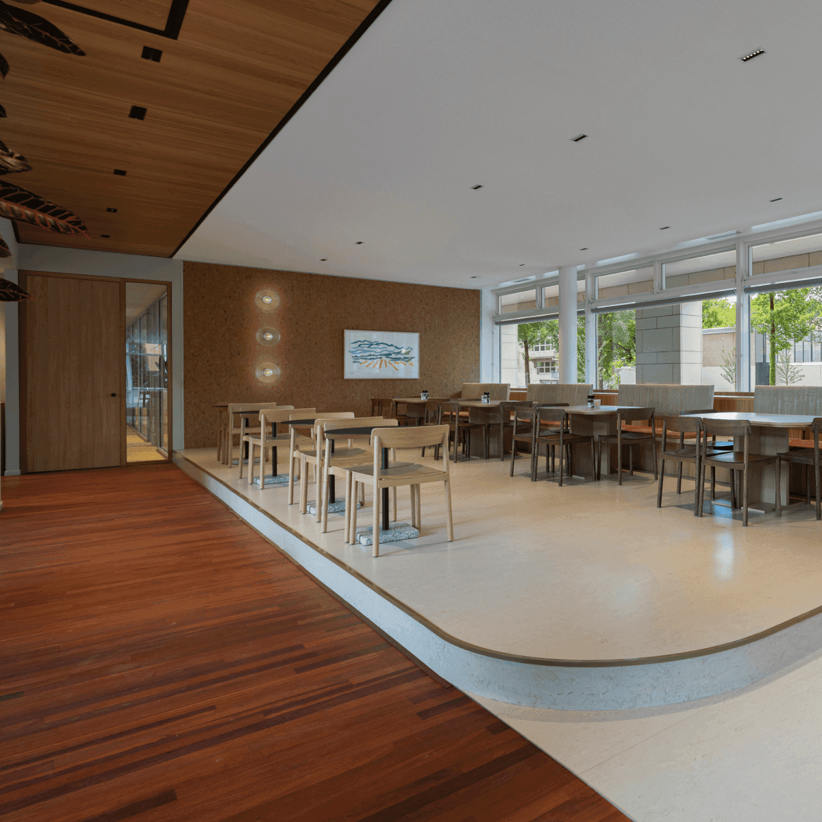 Company restaurant with wooden floor and multiple tables
