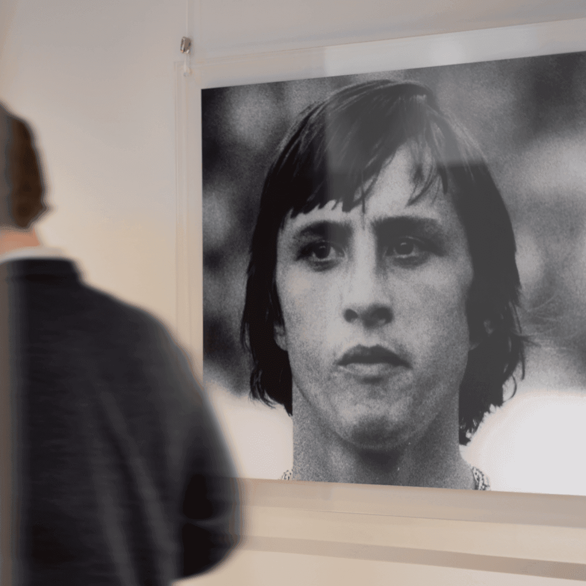 Man looking at black and white portrait in office