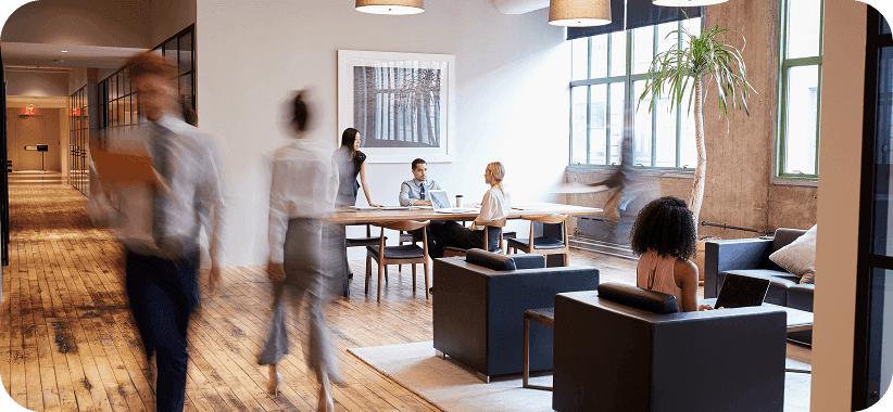 Modern office coworking space with people working and walking