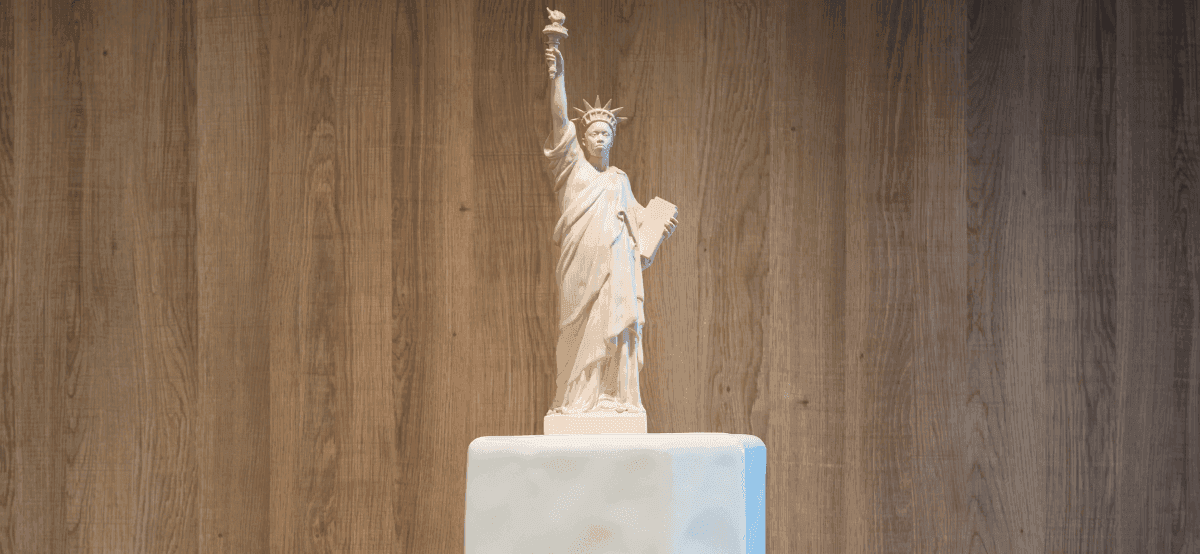 Small statue of liberty on table
